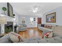 Bright living room showcasing hardwood floors, fireplace and neutral-colored sofas at 1394 Center Lake Dr, Mount Pleasant, SC 29464