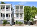 Well-manicured two-story home with double porches and quaint yard at 142 President St, Charleston, SC 29403