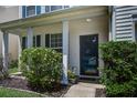 Inviting front porch with decorative shrubs and a charming front door with glass at 2021 Asher Loop, Summerville, SC 29485