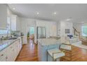 Bright kitchen boasts granite countertops, stainless steel appliances, and a large island with seating at 2028 Prospect Hill Dr, Mount Pleasant, SC 29464