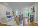 Inviting living room features hardwood floors, a cozy fireplace, and plenty of natural light at 2028 Prospect Hill Dr, Mount Pleasant, SC 29464