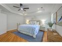 Serene main bedroom offers a tray ceiling, hardwood floors, and a comfortable seating area at 2028 Prospect Hill Dr, Mount Pleasant, SC 29464