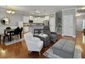 Open-concept living area featuring hardwood floors, stylish furnishings, and an adjacent kitchen at 2064 Promenade Ct, Mount Pleasant, SC 29466
