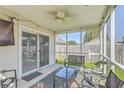 Comfortable screened-in back porch with seating and ceiling fan at 210 Delafield Dr, Summerville, SC 29483