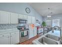 Bright kitchen featuring stainless steel appliances, marble countertops, and stylish backsplash at 210 Delafield Dr, Summerville, SC 29483