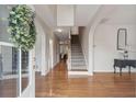 Elegant foyer with gleaming hardwood floors, a staircase, and classic decor at 2267 N Marsh Dr, Mount Pleasant, SC 29466