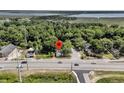 An aerial shot showcases the home's location near a river and bridge, surrounded by lush greenery and convenient roads at 2373 Sorentrue Ave, North Charleston, SC 29405