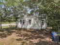 View of the house's back exterior, surrounded by trees and providing a sense of privacy at 2373 Sorentrue Ave, North Charleston, SC 29405
