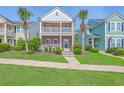 Charming two-story brick home with double balconies, lush landscaping, and sidewalk appeal at 2931 Waterleaf Rd, Johns Island, SC 29455