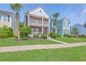Inviting two-story brick home features double balconies, mature landscaping, and neighborhood charm at 2931 Waterleaf Rd, Johns Island, SC 29455