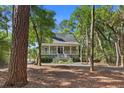 Beautifully landscaped home nestled among mature trees, offering privacy and charm at 3052 Seabrook Island Rd, Seabrook Island, SC 29455