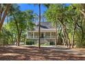 Inviting home with a covered porch, perfect for enjoying the serene surroundings at 3052 Seabrook Island Rd, Seabrook Island, SC 29455
