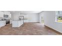 Spacious, open-concept kitchen and living area filled with natural light and stainless appliances at 307 Watersglen Dr, Summerville, SC 29486