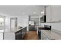 Modern kitchen with gray cabinets, stainless steel appliances, granite countertops, and wood-look flooring at 318 Watersglen Dr, Summerville, SC 29486