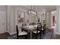 Elegant dining room with a wooden table, seating for six, a blue patterned rug, and decorative lighting at 336 Trailmore Ln, Summerville, SC 29486