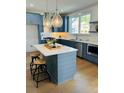 Modern kitchen featuring blue cabinets, stainless steel appliances, and a marble countertop island at 405 Oak Hammock Ct # 49, Johns Island, SC 29455