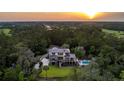 Expansive property boasting a luxury home, pool, and lush greenery against a scenic backdrop at 4121 Golf Cottage Ln, Johns Island, SC 29455
