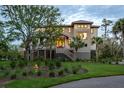 Charming two-story home with manicured lawn and landscaping showcasing coastal charm at 4121 Golf Cottage Ln, Johns Island, SC 29455