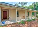 Welcoming covered front porch with a hanging swing and views of the front yard at 441 Compton Dr, Moncks Corner, SC 29461