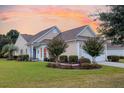 Charming home featuring mature landscaping, lawn, and an inviting entrance at 528 Sea Foam St, Summerville, SC 29486