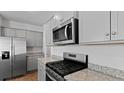 Modern kitchen with stainless steel appliances, granite countertops and gray cabinets at 807 Long Bluff Rd, Summerville, SC 29486