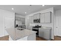 Bright kitchen featuring stainless steel appliances, granite countertops and gray cabinets at 807 Long Bluff Rd, Summerville, SC 29486