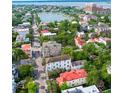 High aerial view of a city street with many homes, green trees, and a body of water in distance at 81 Rutledge Ave, Charleston, SC 29401
