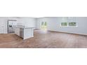 Bright living space with wood-style floors, connecting the kitchen with an island and stainless appliances at 810 Long Bluff Rd, Summerville, SC 29486