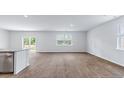 Open concept living room with natural light, wood-style flooring, and sliding door access to the outside at 810 Long Bluff Rd, Summerville, SC 29486