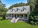 Inviting home with a classic facade, dormer windows and a welcoming front porch at 820 Old Cordesville Rd, Moncks Corner, SC 29461