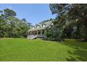 Classic home nestled among mature trees, offering a serene and private setting at 820 Old Cordesville Rd, Moncks Corner, SC 29461