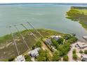 Aerial view of luxurious waterfront homes with private docks and expansive coastal marshland at 104 Beach St, Mount Pleasant, SC 29464