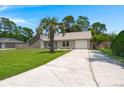 Well-maintained home featuring a concrete driveway, lovely lawn and a mature palm tree at 106 Brown Ct, Summerville, SC 29486