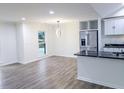 Open-concept kitchen and dining area with hardwood floors, stainless steel appliances and natural light at 132 Tranquil Ln, Ladson, SC 29456
