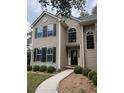Two-story home with neutral siding, black shutters, manicured landscaping, and a concrete walkway to the front door at 1330 Somersby Ln, Mount Pleasant, SC 29466