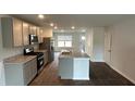 Modern kitchen boasts a spacious island, stainless steel appliances, and sleek countertops at 137 Haventree Ct, Summerville, SC 29486