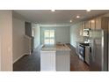 Open-concept kitchen seamlessly connects to the living area, providing a versatile space for dining and entertaining at 137 Haventree Ct, Summerville, SC 29486