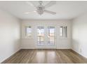Bedroom with light hardwood floors and sliding glass doors to a balcony with water views at 138 W Mariners Cay Dr, Folly Beach, SC 29439