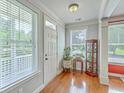 Bright foyer with hardwood floors, a charming curio cabinet, and lots of natural light at 1408 Bimini Dr, Charleston, SC 29414