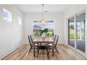 Bright dining room featuring modern chandelier lighting, a stylish table, and expansive windows at 141 Summerwind Dr, Summerville, SC 29483