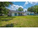 A single-story home with teal shutters, solar panels, and a well-maintained lawn at 171 N Main St, Ridgeville, SC 29472