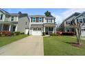 Charming two-story home featuring a well-maintained lawn and a driveway leading to a one-car garage at 1800 Poplar Grove Pl, Summerville, SC 29483