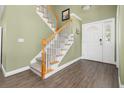 Inviting entryway with hardwood floors, stairs leading to upper level, and bright natural light at 1813 Parkland Preserve Ln, Charleston, SC 29412