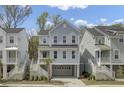 Charming two-story coastal home with a covered porch, white railings, and a convenient ground-level garage at 1821 Mead Ln, Johns Island, SC 29455