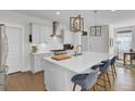 Bright kitchen featuring white cabinets, a center island with seating, and stainless steel appliances at 1821 Mead Ln, Johns Island, SC 29455