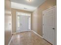 Inviting entryway featuring tile floors, a white front door with sidelights, and neutral paint at 183 Cypress Forest Dr, Moncks Corner, SC 29461