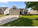 Charming single-Gathering home showcasing a manicured lawn, a driveway, and a two-car garage at 183 Cypress Forest Dr, Moncks Corner, SC 29461