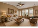 Cozy living room boasts a high ceiling, neutral paint, a ceiling fan, and ample natural light at 183 Cypress Forest Dr, Moncks Corner, SC 29461
