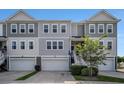 Charming gray townhome with well-maintained lawn and attached garage at 185 Winding River Dr, Johns Island, SC 29455