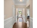 Welcoming entryway with hardwood floors, detailed wainscoting, and a view to the front door at 207 Brutus Ln, Summerville, SC 29485
